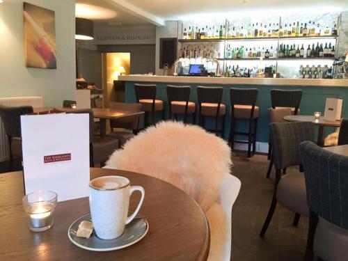 a coffee cup on a table in a restaurant at Kirklands Hotel in Kinross