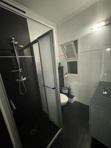 a bathroom with a shower and a toilet and a sink at Premium Studio Eilot Street 89B in Eilat