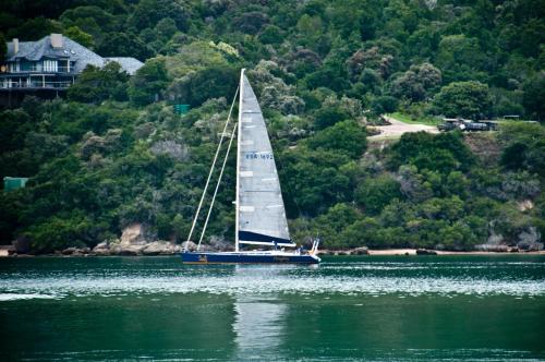a sailboat floating on the water in a lake at The Knysna Belle Guest House in Knysna