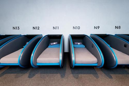a row of empty seats on an airplane at Sleepover Doha North Node - formerly sleep 'n fly in Doha