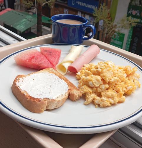 a plate of breakfast foods with a cup of coffee at Hotel Condina Pereira in Pereira