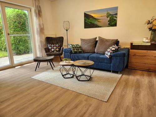a living room with a blue couch and a table at Winzerhof Düring in Iphofen