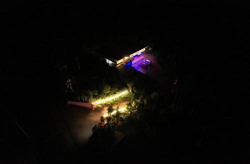 an overhead view of a building with lights at night at Janhavi Homestay in Napoklu