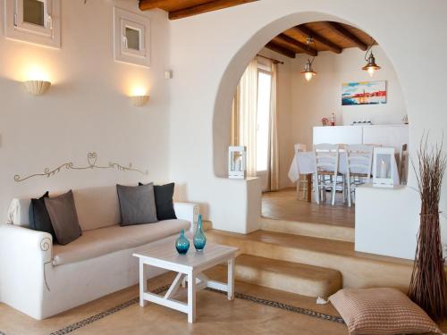 a living room with a couch and a table at Villa in Mykonos near Agios Sostis Beach in Agios Sostis Mykonos