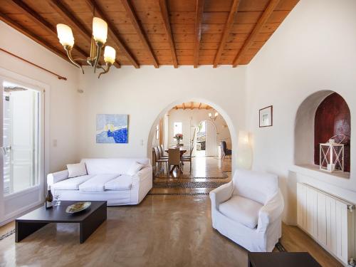 a living room with two white couches and a table at Villa in Mykonos near Agios Sostis Beach in Agios Sostis Mykonos