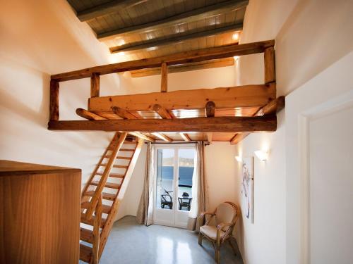 a loft bed in a room with a ladder at Villa in Mykonos near Agios Sostis Beach in Agios Sostis Mykonos
