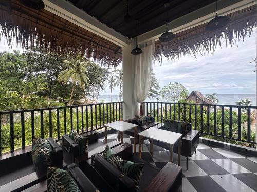 a living room with a view of the ocean at The French Villa-Santander Cebu in Santander