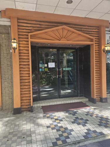 an entrance to a building with a revolving door at Hotel City Star in Sandakan