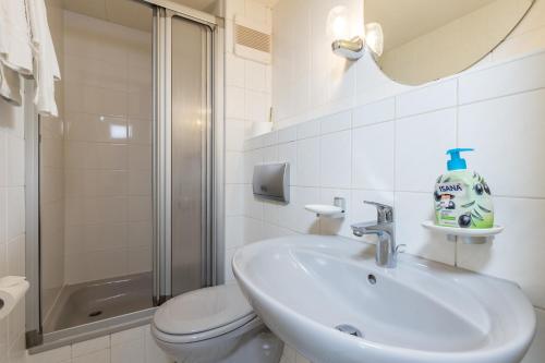 a bathroom with a sink and a toilet and a shower at Gästehaus Anita in Gailingen