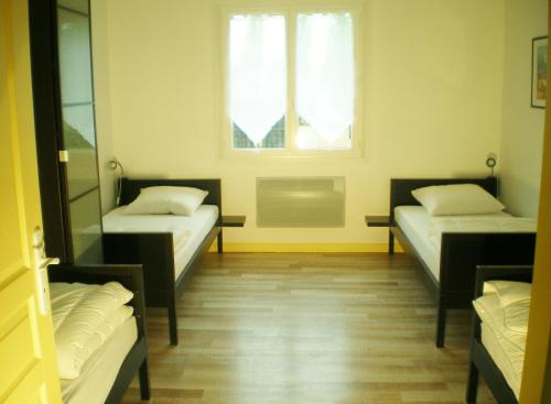 Cama o camas de una habitación en Le Gîte de la Faïencerie