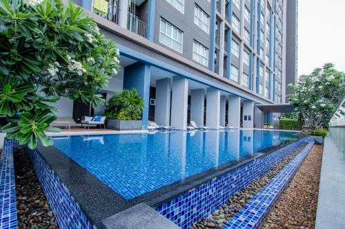 a swimming pool in the middle of a building at Baan Kiang Fah Apartment by Patcha in Hua Hin