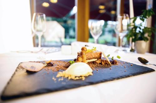 a plate of food on a table with wine glasses at Hotel Villa Medici in Bad Schonborn