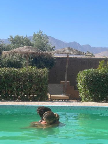 a person in the water in a swimming pool at Tigmmi N Usnful in Amizmiz