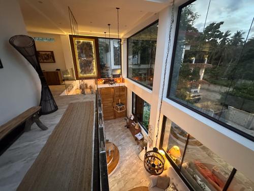 a room with two large windows and a table at The French Villa-Santander Cebu in Santander