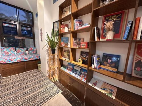 a room with a book shelf with books at The French Villa-Santander Cebu in Santander