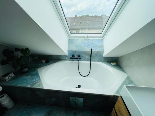 a bath tub in a bathroom with a window at Urlaub im fränkischen Seenland in Allersberg