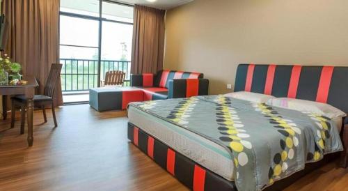 a bedroom with a bed and a couch and a table at Happy Village Kundasang in Ranau