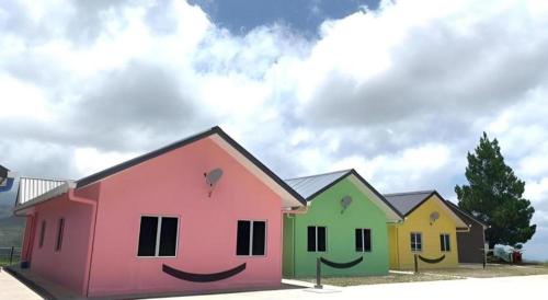 a group of houses painted with a smiley face at Happy Village Kundasang in Ranau