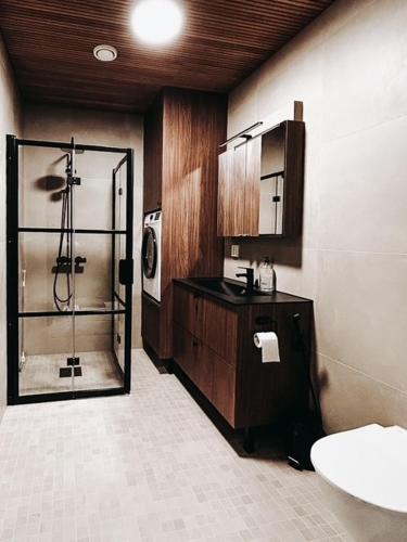 a bathroom with a shower and a sink at Neliapila's two-room apartment in Kokkola