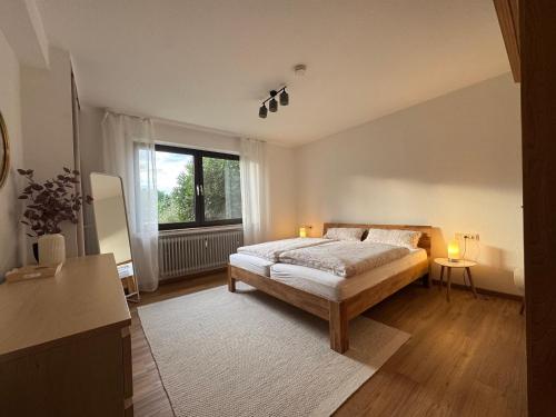 a bedroom with a bed and a large window at Appartement Abendsonne in Rotenburg an der Fulda