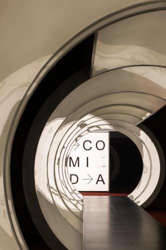 a spiral staircase with a sign on it at SFEEL设计师酒店Designer Hotel成都太古里滨江路店 in Chengdu