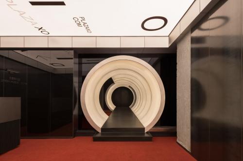 a spiral staircase in a building with a statue at SFEEL设计师酒店Designer Hotel成都太古里滨江路店 in Chengdu