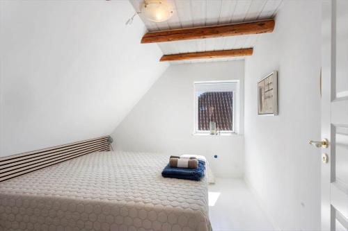 a bedroom with a bed in a white room at AE316-Aeroskobing-Oster-Bregninge-45 in Ærøskøbing