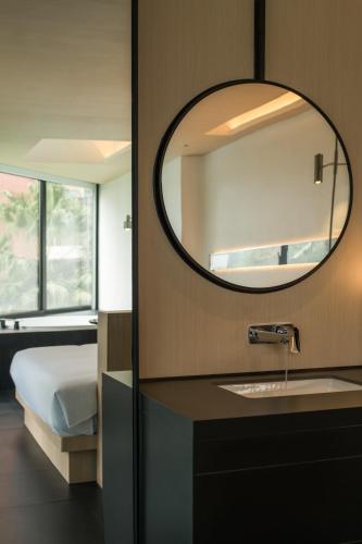 a bathroom with a sink and a mirror at SFEEL设计师酒店Designer Hotel成都太古里滨江路店 in Chengdu