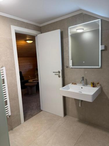 a bathroom with a white sink and a mirror at Alpin Borovets, Алпин Боровец in Borovets