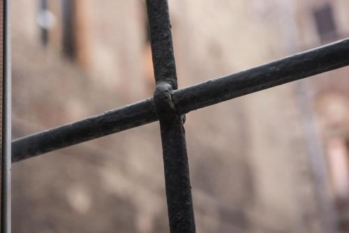 a close up of a black metal fence at La Terrazza Sul Campo-Rooms Only in Siena