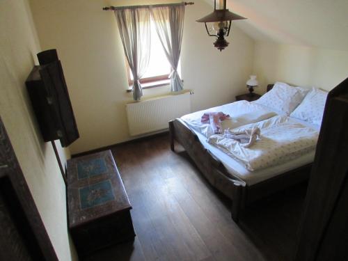 a bedroom with a bed with stuffed animals on it at Pension Kamenný Dvůr in Františkovy Lázně