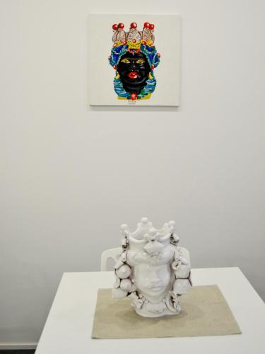 a white vase sitting on a table in a museum at Abraxia Guest House in Comiso