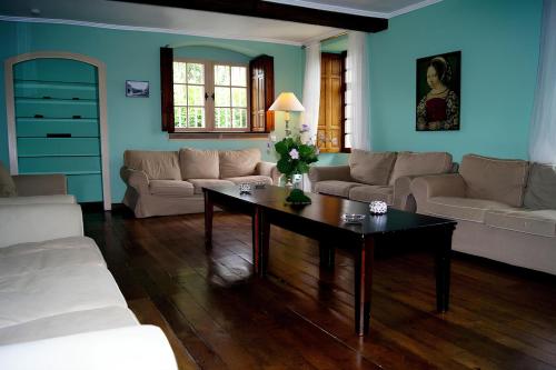 a living room with a couch and a coffee table at La Madeleine in Nassogne