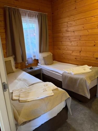two twin beds in a room with a window at Alpin Borovets, Алпин Боровец in Borovets