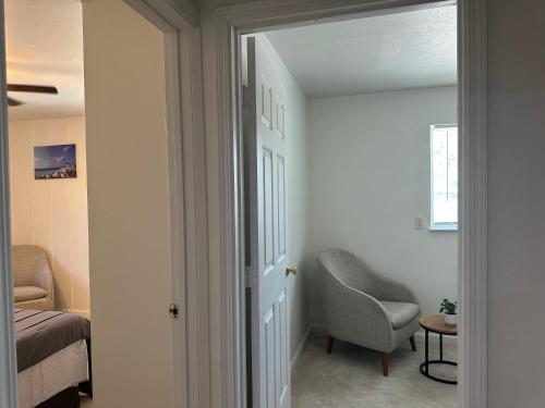 a room with a chair and a bed and a window at Suite E with 2-bedroom in Sacramento