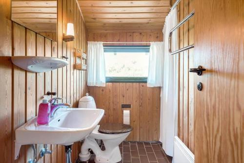 a bathroom with a sink and a toilet at TV1349-Bindslev-Paradisdalen-24 in Bindslev