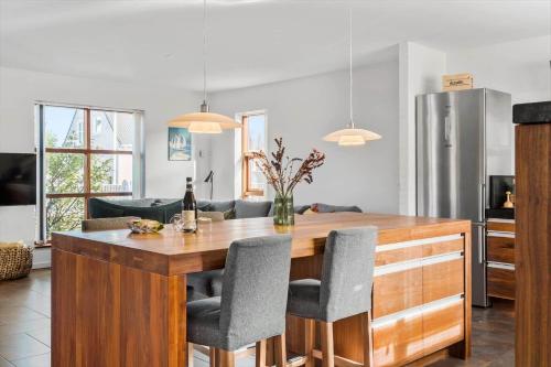 a kitchen with a wooden table and chairs at TV1518-Albaek-Sdr-Havnevej-20 in Ålbæk