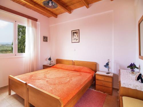a bedroom with a bed and a window at Villa in Lefkogia near Souda Beach in Lefkogeia