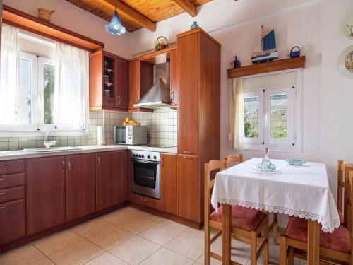 a kitchen with a table with a white table cloth on it at Villa in Lefkogia near Souda Beach in Lefkogeia