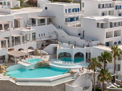 an aerial view of a building with a swimming pool at Mykonos Blu, A Grecotel Resort to Live in Psarou