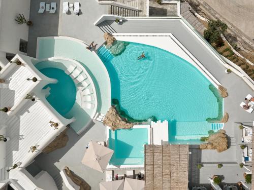 an overhead view of a swimming pool in a resort at Mykonos Blu, A Grecotel Resort to Live in Psarou