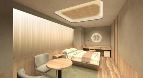 a bedroom with a bed and a desk and a table at Hotel Ann Tsukiji in Tokyo