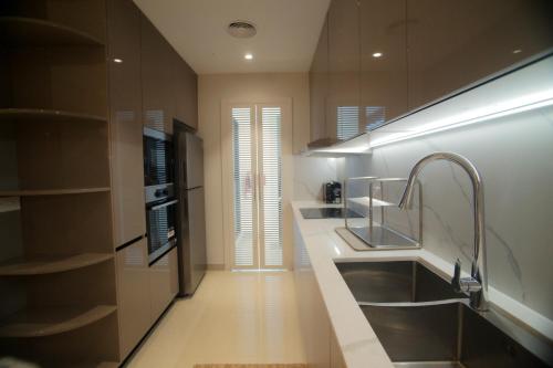 a bathroom with a sink and a faucet at Liaqat Airport Residence Al Mouj in Mawāliḩ