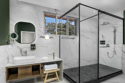 a bathroom with a shower and a sink at Fairview Hotel Nairobi in Nairobi