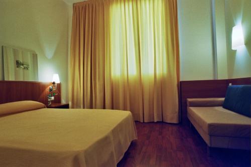 Ένα ή περισσότερα κρεβάτια σε δωμάτιο στο Hotel Berga Park
