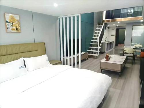 a bedroom with a bed and a living room and a staircase at Blue Coast Hotel in Chengdu