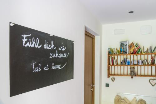 a chalkboard sign on a wall in a room at Haus Karin living in Brixen