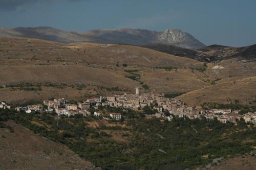 a small village in the hills with mountains at Albergo Ristorante Monte Selva in Barisciano
