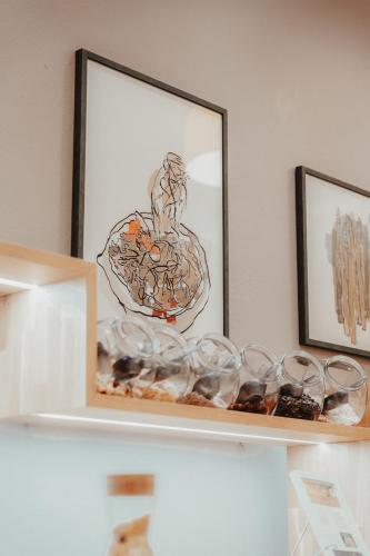 a shelf with glasses on it with a picture at Hotel Villa Medici in Bad Schonborn