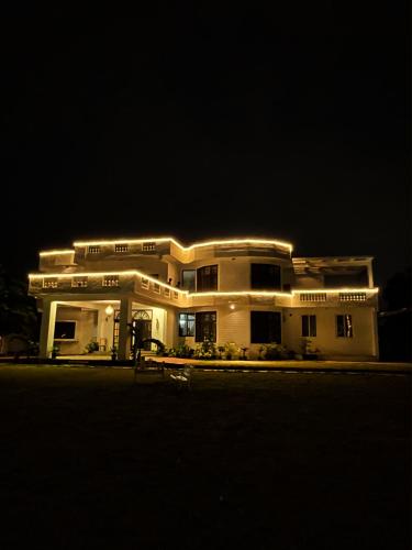 a large white building with lights on it at night at Le Roma Vista in Bengaluru